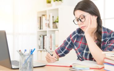 bored young woman with laptop computer