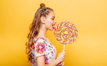 woman-with-playful-look-eating-candy