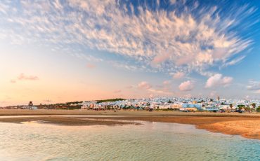 Sand beach of Playa de Roche and ocean at sunset, Conil de la Frontera, Costa de la Luz, Cadiz Province, Andalusia, Spain